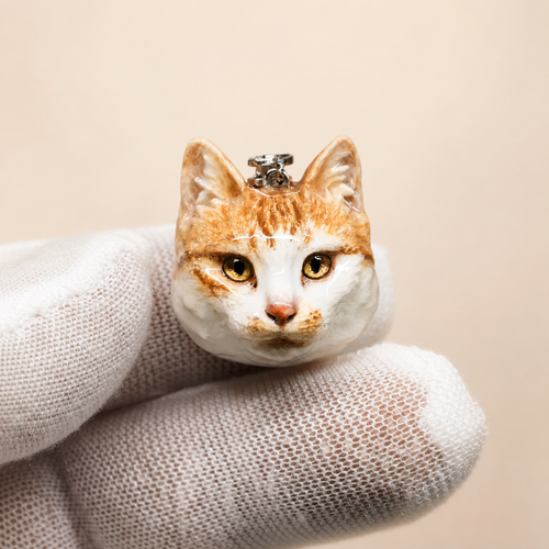 Custom orange and white cat clay necklace pendant, front view