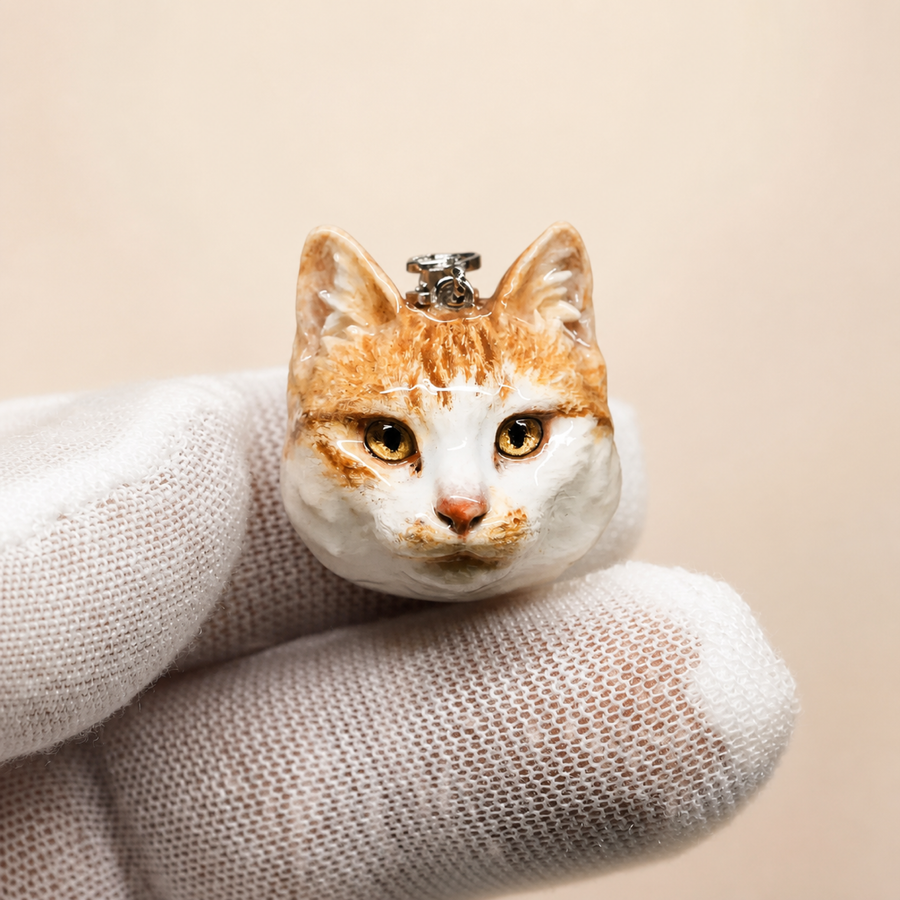 Close-up of a hand-sculpted custom cat portrait pendant
