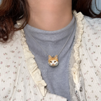 Custom cat clay necklace worn by a model, natural lifestyle view